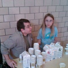 John and Faith's child Rowan, during a volunteer West Elementary event at the beverage stand