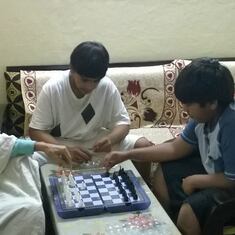 Playing chess with grandsons, his favorite game, for the very last time