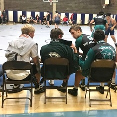 Team Captain Eric Torvo sitting on Jordan's Lap, far right. Just another day wrestling with the people you love