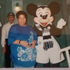 At Disneyland meeting Mickey Mouse in 1993. Pictured with her father. 