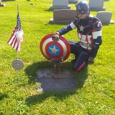Art my oldest dressed as captain American at my dad's grave 