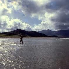 Joe sprinting through the Atlantic Ocean after a long, hot, bike journey. Ireland, Dingle Peninsula.