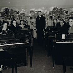 8 pianos - I believe the lady at the piano behind Joyce is Gladys Lusgraff.  All the way back - Edna Jorgenson