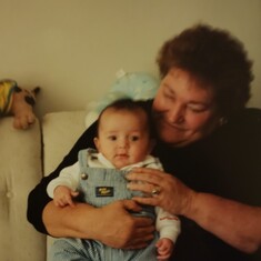Juanita holding granddaughter Emily in 1997