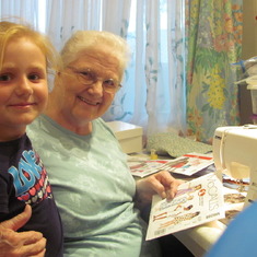 Teaching her granddaughter to sew