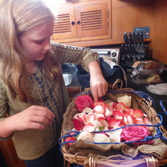 Granddaughter decorating basket of ashes