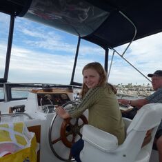 Granddaughter Kathryn at the wheel - with Captain nearby