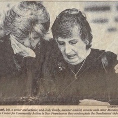 Front Page SF Chronicle, Feb 1990, Sally Gearhart, left, and Judy Brady, console each other at the Nicaraguan Center for Community Action in San Francisco as they contemplate the Sandinistas defeat.