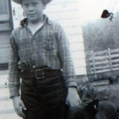 Jule with his dog "Blackie" standing in front of his home in Rapid City, South Dakota