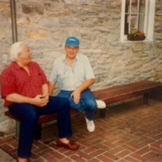 Jule and Jack Orth, his dear friend sit, talk and joke on one of the many benches they discovered outside of stores over the years