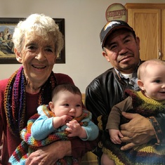Grandma and Miguel holding Hannah and Bri