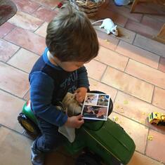 Julian, very interested by the truck held by Theo on the postcard we sent