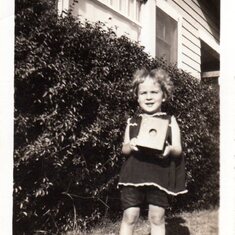 June holding an old box camera