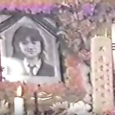 A picture surrounded by flowers at Junko Futura's funeral.