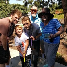 Grammy and Papa playing minigolf Zack, Tyler, and Andrew