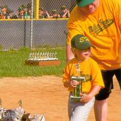This is the last game of the 2009 Tball season. This was the only season Kaylee played Little League. Kaylee is pictured with her daddy getting her trophy, and no father could have been prouder than he was of Kaylee. She truly was a daddy's girl.
