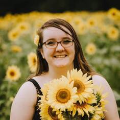 Kayley surrounded by her favorite flower.