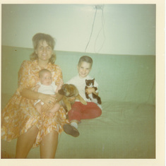 Baby Kelly sitting on mother’s lap Joyce Woodmansee Gallacher brother Hal III also new German puppy a Siamese cat. Kelly’s blooming love for family puppies and kittens Vegas Tonopah Hwy 1966