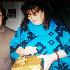 Mom and Dad @ Christmas opening a gift from Sherri and Anthony (airline tickets to FL)
