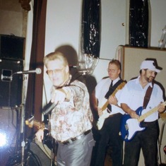 Uncle Charlie is pointing @ the camera and Dad is in the back playing guitar @ my reception 1992