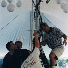 "Here's another great memory of Ken;  steadying the ladder for Peter Wiley (known for being deathly afraid of heights) charged with the task of mounting he lighting within the tent @ Mary Kelly's cottage; who graciously hosted Kim & Ken's reception, becau
