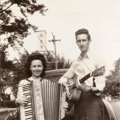 Granddad with a random lady carrying a random instrument.