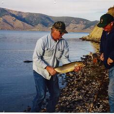 Kenton assisting Kevin with his monster trout. Henrys Lake, Idaho. Oct 1998