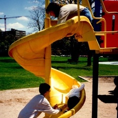 mom and cody help avery down the slide