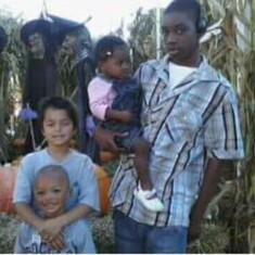 Kimani and his siblings at a pumpkin Patch