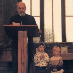 Opa Forster preaching with the help of his 2 grandsons