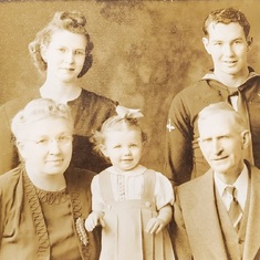 With grandparents in the front row, mother and uncle standing behind