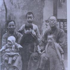 Circa 1936, at the recreation building at the YMCA compound.  Dad at top, with Grandmother and Grandfather seated.  In front are Dad's youngest sister and first sister.