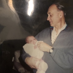 Larry holding his granddaughter, Allie as a baby.