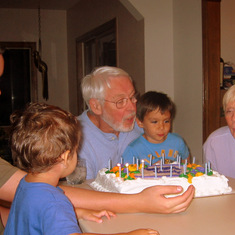 Oscar and Owen help their great grandpa blow out his birthday candles, about 2004