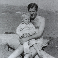Dad holding Greg at the beach