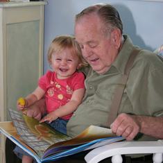 dad reading to Josie, laughing