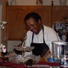Lawrence doing what he loved, serving others joyously cooking one of his many delicious meals!