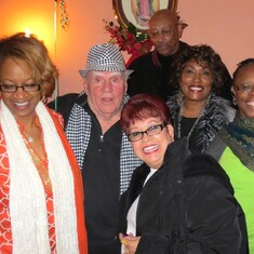 Larry surrounded by friends at his 80th birthday party.