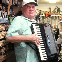 Larry at his store playing his accordion