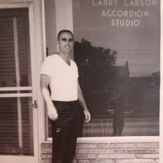 Larry standing in front of his music store when it was an accordion studio