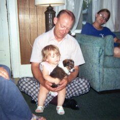 Larry holding his cute grandchild, Angie and a cute puppy named Max. Happy Birthday, Larry. We all miss you so much.