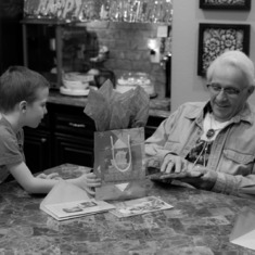 Both born on Nov. 17, Henry eagerly watching his grandpa opening his present. Henry & Charlie turning 5 while Dad turned 75 (2013)