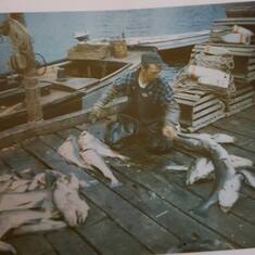 Leonard cleaning his fish in Neils Harbour Nova Scotia.