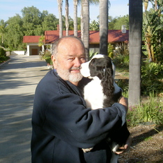 With Bentley, our neighbors’ springer spaniel. Les was never happier than when holding a puppy.
