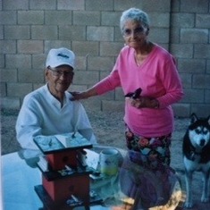 Les and Viv in Phoenix, having a cup of coffee with Melody's dog Dakota. Notice one of Les' hand made bird houses on the table.