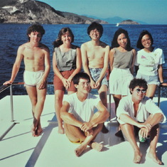 Lew seated on pleasure boat with Deborah behind, Hong Kong 1990
