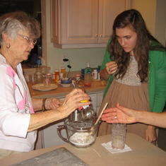 Grandma teaching Sarah how to make her peanut brittle