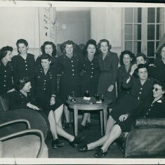 1945 April - Lois' note on back: "Don't know many of these girls or those I was standing with.  Had my mouth open as ususal,  My uniform is the combat suit we used here.. Apr. 45"