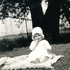 One year old Lois, picnicking in the park. 