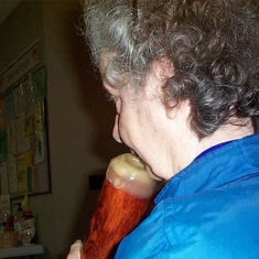 Lori tries the Didgeridoo at CC Unity church concert and workshop.